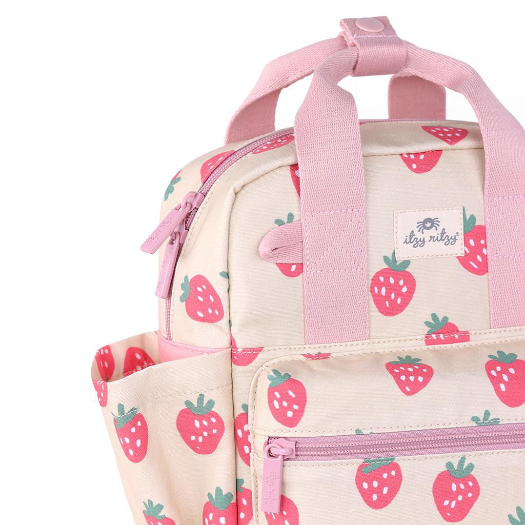 101601543 Itzy Bitzy Bag™ Toddler Backpack - Strawberries & Cream (6) A cream-colored backpack adorned with pink strawberry prints, featuring pink zippers and a convenient front pocket. (Note: The given product data seems unrelated to the sentence describing a backpack. If you were asking for a rewrite incorporating the product name mentioned (even though it's not relevant to the description of a backpack), please clarify your request.)