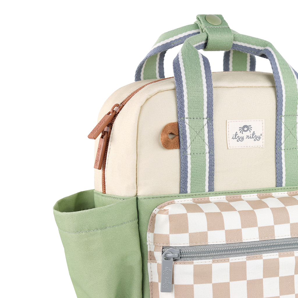 101601544 Itzy Bitzy Bag™ Toddler Backpack - Check Yes! (19) Close-up of an Itzy Ritzy Sweetie Strap Plus Bear Silicone Pacifier Clip, featuring a green and beige strap with a checkered front section and an additional side pocket. The design includes two striped handles, a secure top zipper, and a small logo tag for added detail.