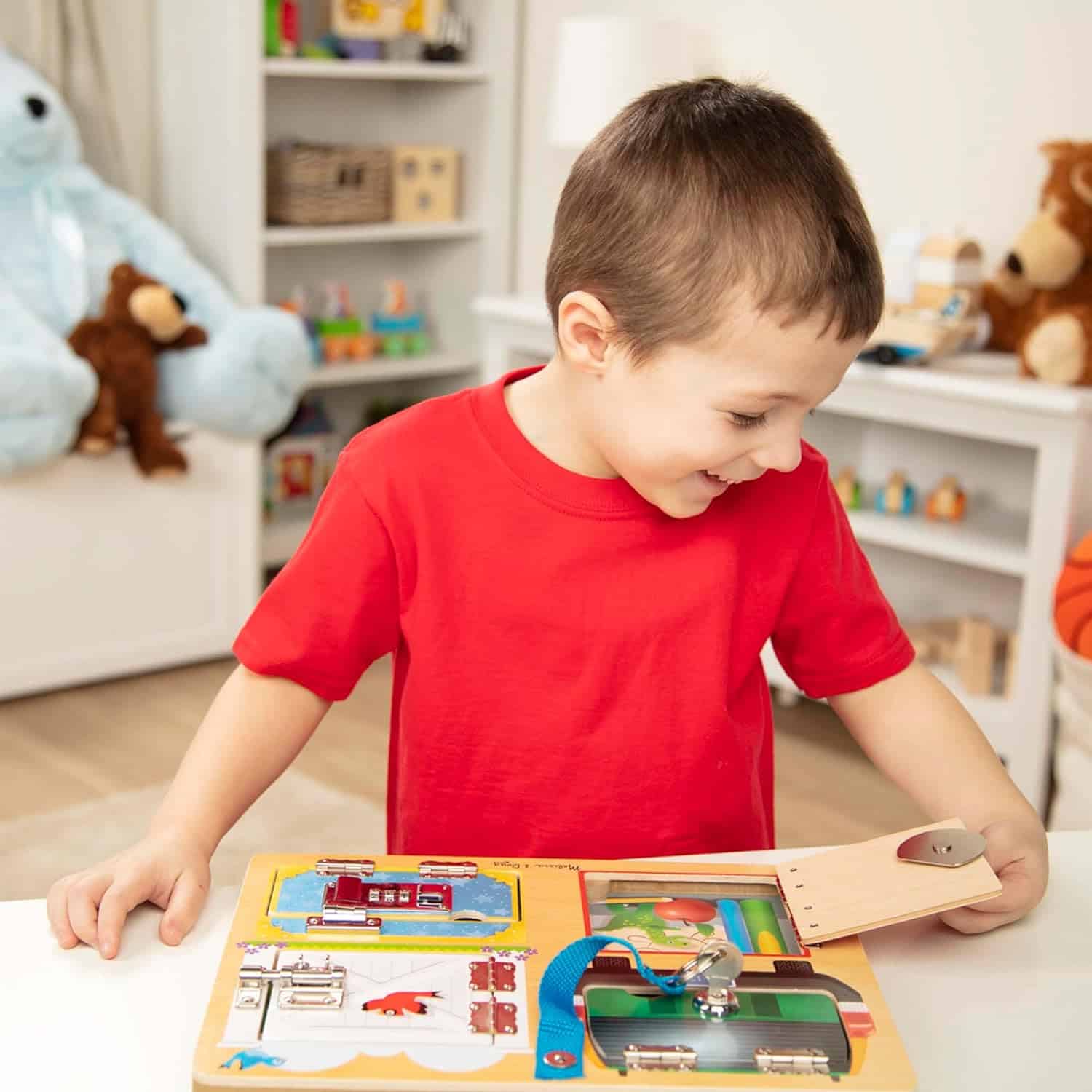 Melissa-and-Doug-Locks-and-Latches Board-Wooden Educational-Toy-9540 (5) A young boy playing with a Melissa & Doug Locks and Latches Board.