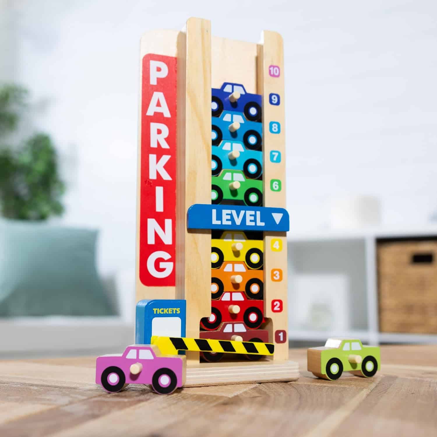 A Melissa & Doug Stack & Count Wooden Parking Garage with 10 Cars toy.