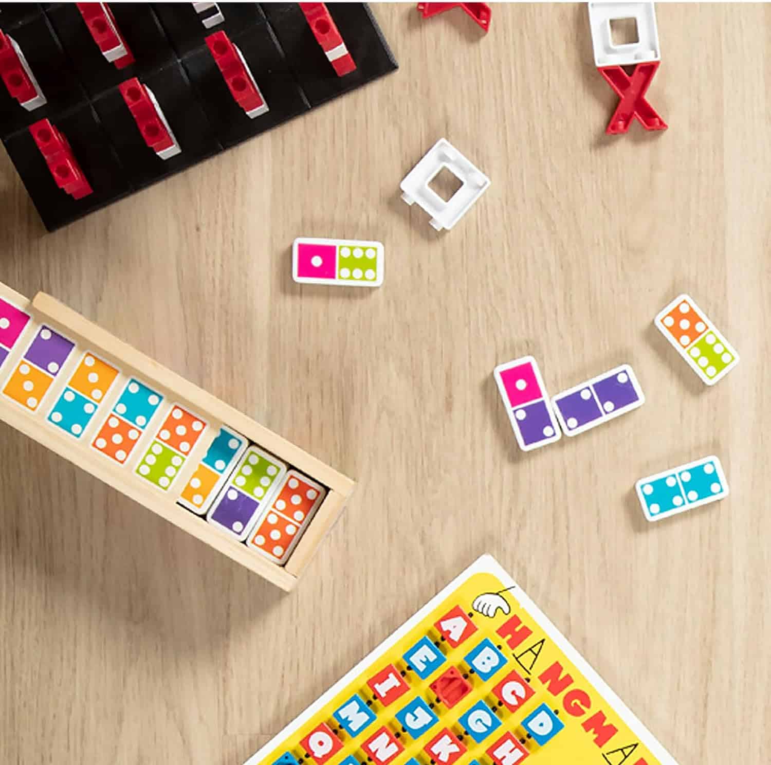 Melissa & Doug Dominoes Tabletop Game 28 Colorful Tiles MD30388 (3) A set of Melissa & Doug Dominoes Tabletop Game 28 Colorful Tiles on a wooden table.