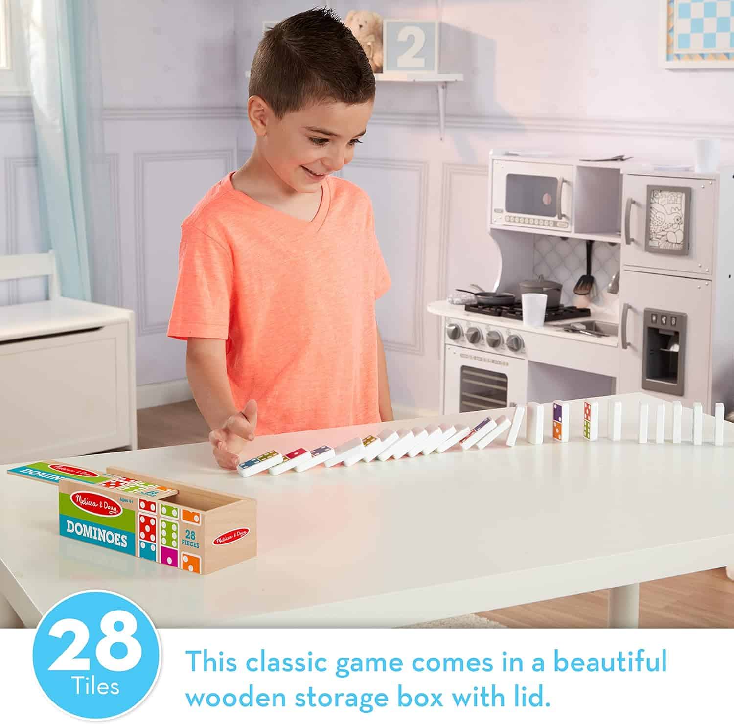 Melissa & Doug Dominoes Tabletop Game 28 Colorful Tiles MD30388 (7) A boy is playing with Melissa & Doug Dominoes Tabletop Game 28 Colorful Tiles in a kitchen.