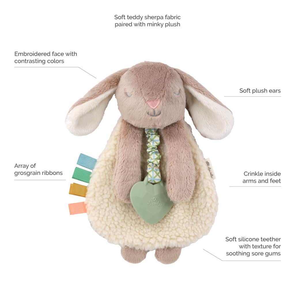 302801555 Itzy Lovey Taupe Bunny Plush bunny toy with sherpa fabric, soft ears, embroidered face, crinkle arms, grosgrain ribbons, and a silicone teether on a ribbon.