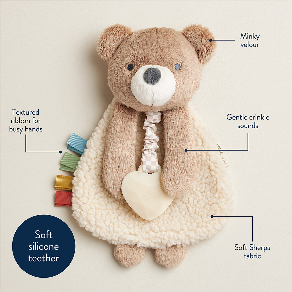 302801667_Itzy_Ritzy_Itzy_Lovey_Bear A plush bear toy made of minky velour and soft Sherpa fabric with a soft silicone teether, textured ribbon tabs, and a gentle crinkle sound feature.