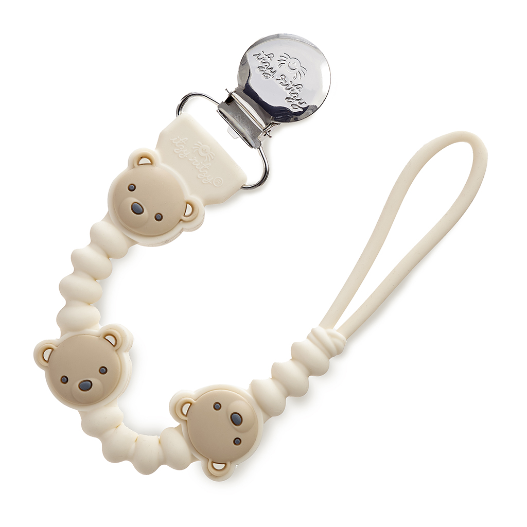 705101559 Sweetie Strap Plus™ Bear (1) The Itzy Ritzy Sweetie Strap Plus Bear Silicone Pacifier Clip is a baby pacifier clip adorned with teddy bear designs, featuring a loop at one end for attachment and a metal clip at the other end for fastening to clothing.