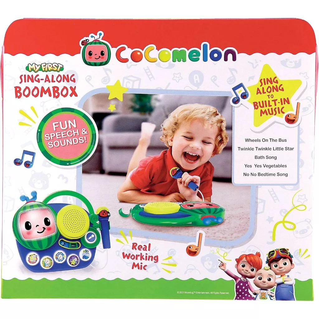Cocomelon Toy My First Sing Along Boombox Working Microphone Music Singalong Toddler (5) Image of a Cocomelon Toy ‘My First Sing Along Boombox’ packaging featuring a child playing with the toy. Text highlights include "Fun Speech & Sounds!", "Sing Along to Built-In Music!", and "Real Working Microphone.