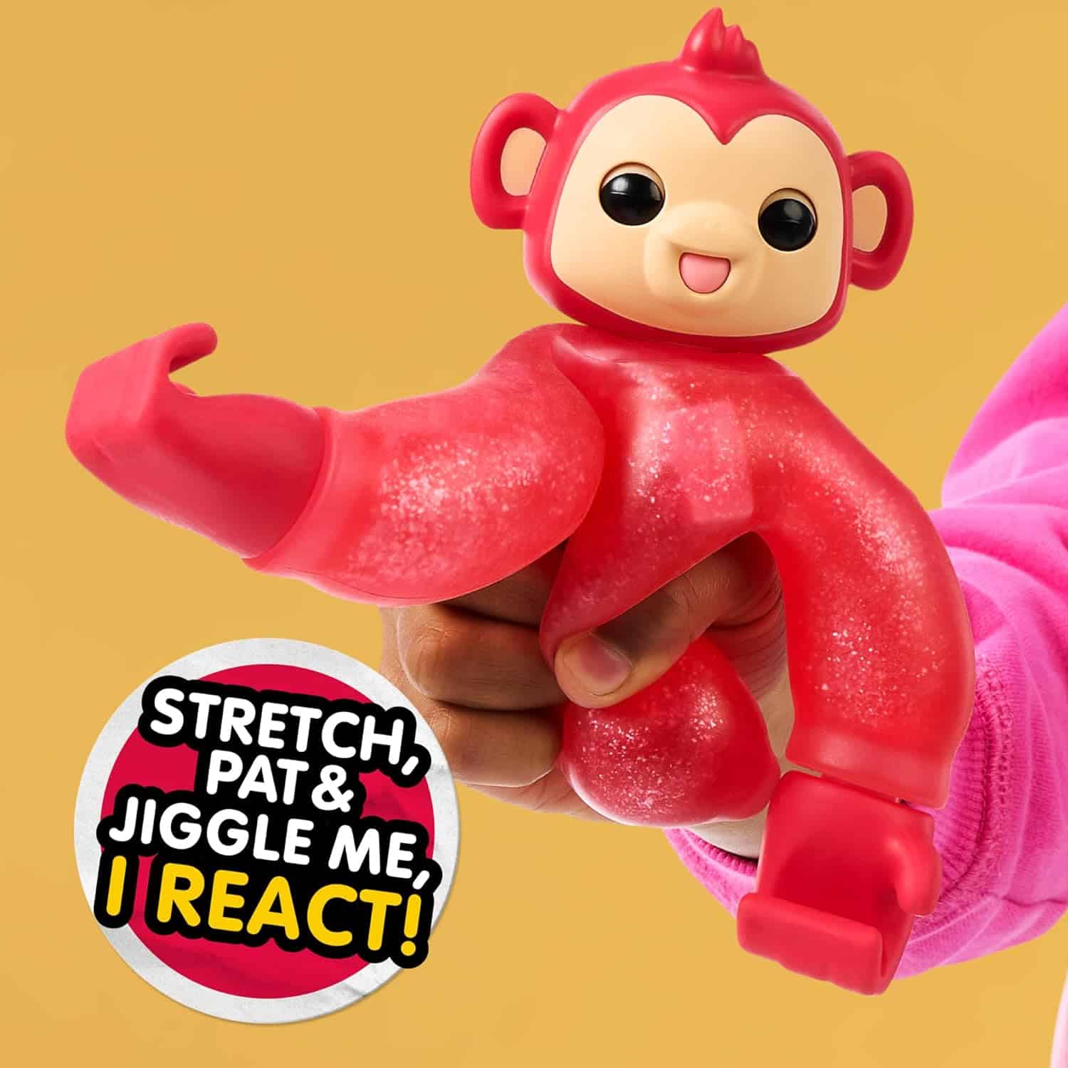 Little Live Pets Hug n' Hang Zoogooz - Mookie Monkey. an Interactive Electronic Squishy Stretchy Toy Pet with 70+ Sounds & Reactions. Stretch, Squish & Link Their Hands Medium (10) Hand holding a red stretchable toy monkey with a happy face. Text on the image reads, "Stretch, pat, and jiggle me, I react!.