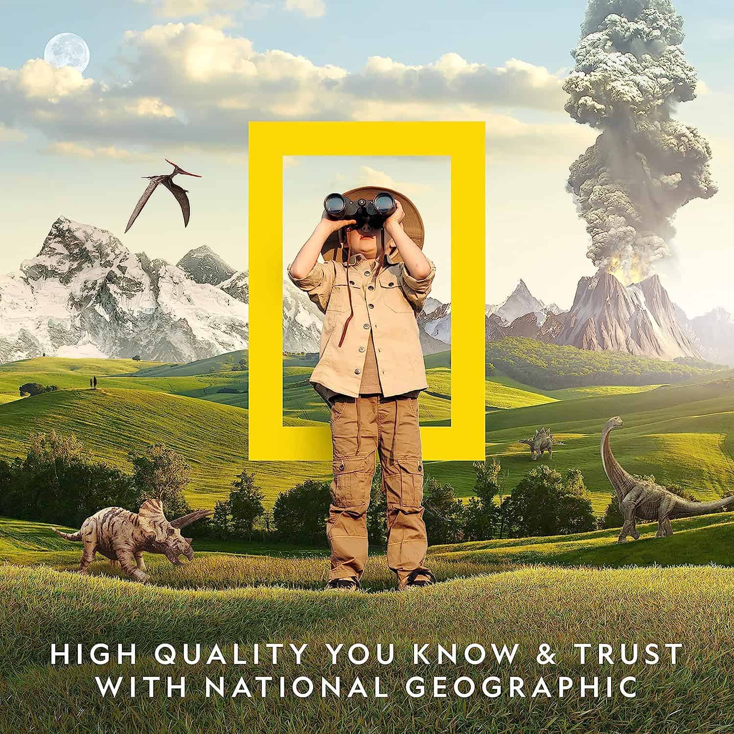 NATIONAL GEOGRAPHIC Break Open 10 Premium Geodes (1) A child in safari clothing looks through binoculars in a prehistoric-themed landscape with dinosaurs, mountains, and a volcano. The National Geographic logo is in the background with text beneath: "National Geographic Break Open 10 Premium Geodes.