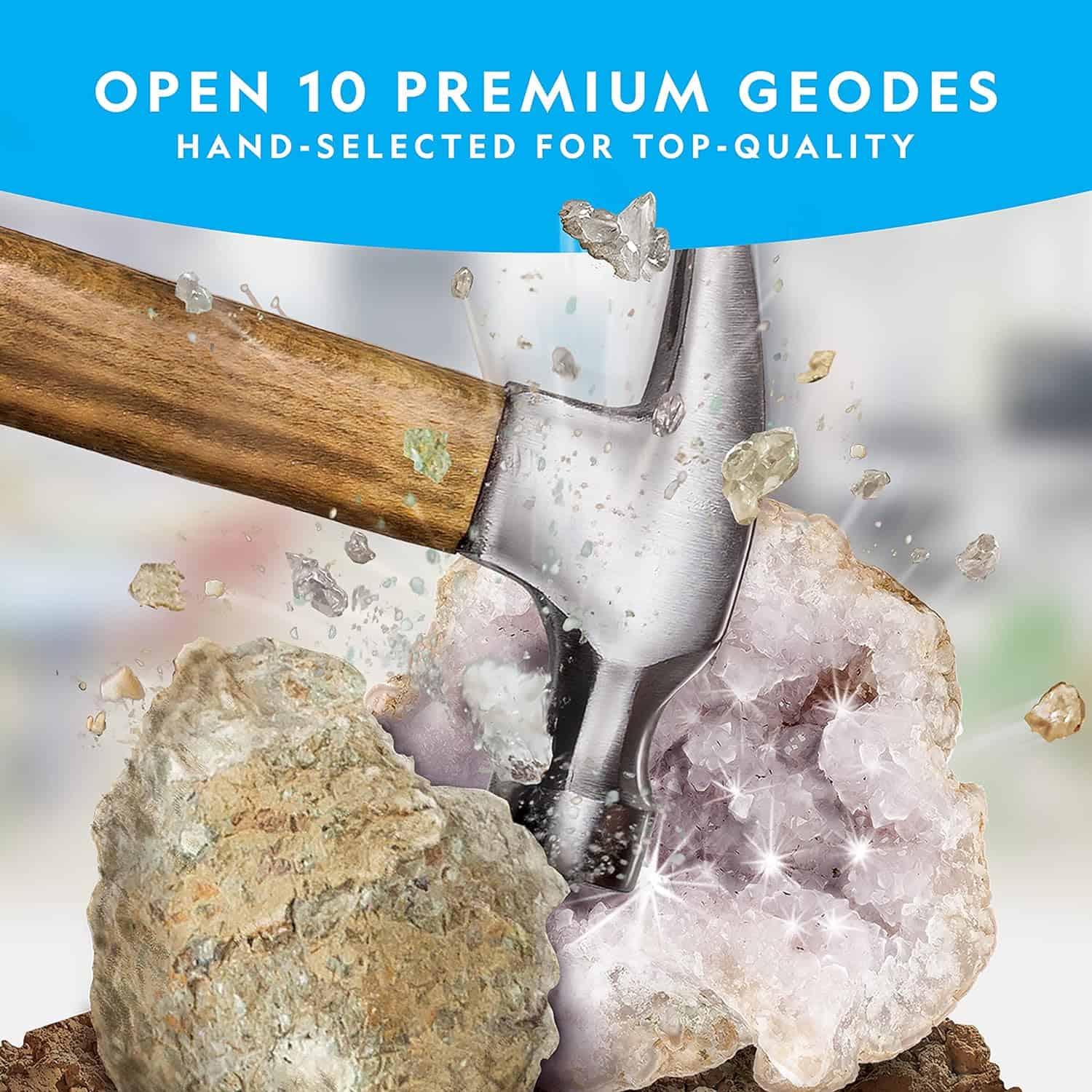 NATIONAL GEOGRAPHIC Break Open 10 Premium Geodes (5) A hammer breaking open a geode, revealing glittering crystals inside. Text above reads, "National Geographic Break Open 10 Premium Geodes - Hand-Selected for Top-Quality.