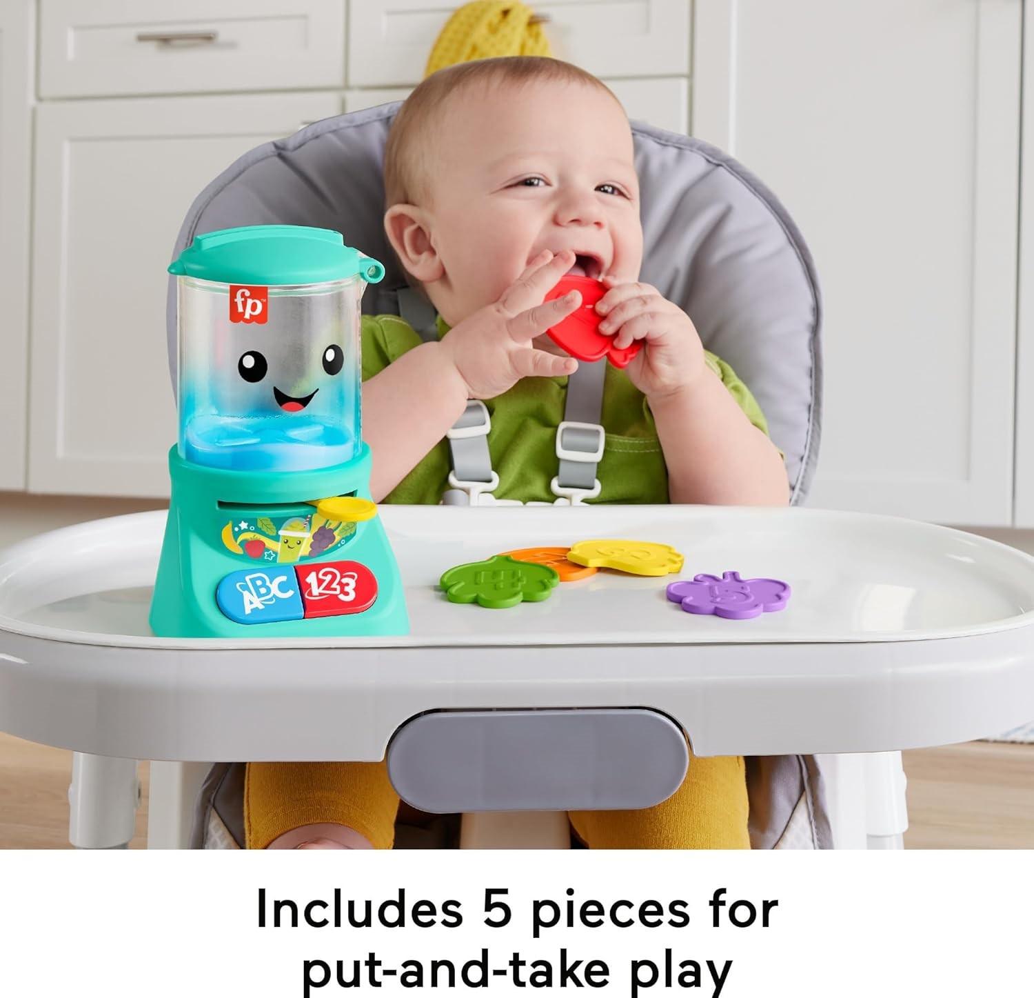 fisher-price-laugh-learn-counting-colors-smoothie-makers (2) A baby sits in a high chair, playing with a colorful toy set. The Fisher-Price Laugh & Learn Baby & Toddler Toy Counting & Colors features a smiling container and various shapes. Text at the bottom reads, "Includes 5 pieces for put-and-take play.”