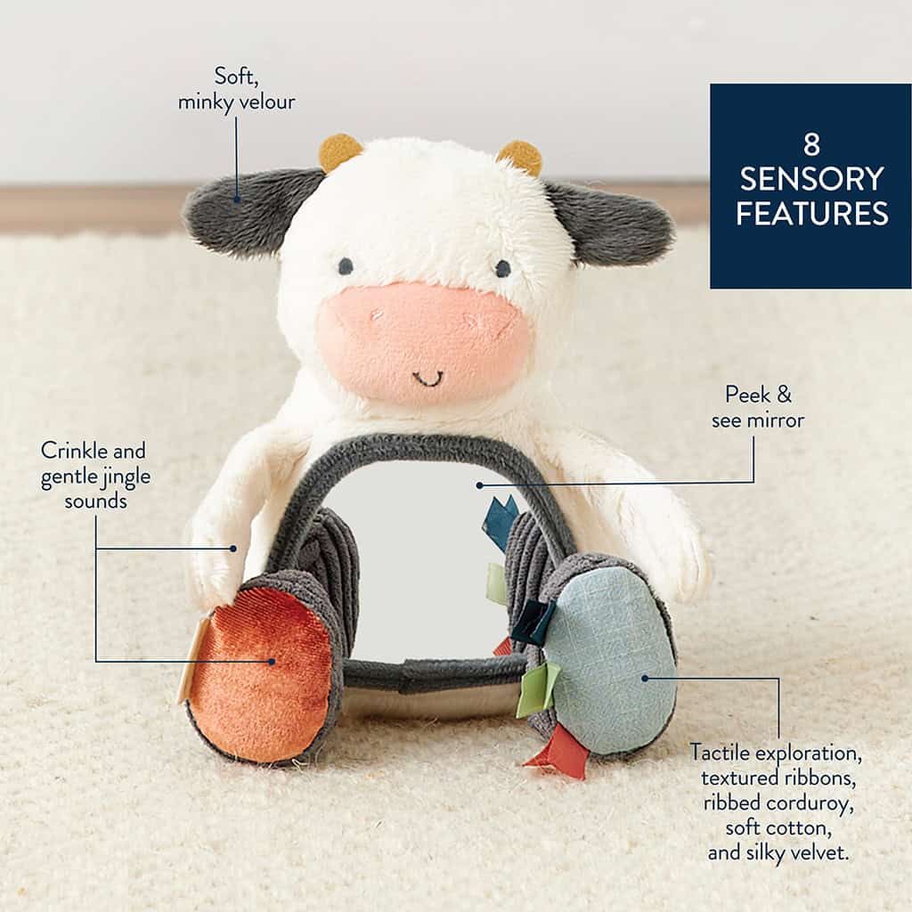 itzy-ritzy-306601562-itzy-bitzy-mirror-cow-3 A plush cow toy featuring a soft, minky velour surface. It has crinkle and jingle sounds, a peek-and-see mirror, and diverse textures like ribbed corduroy, soft cotton, textured ribbons, and silky velvet.