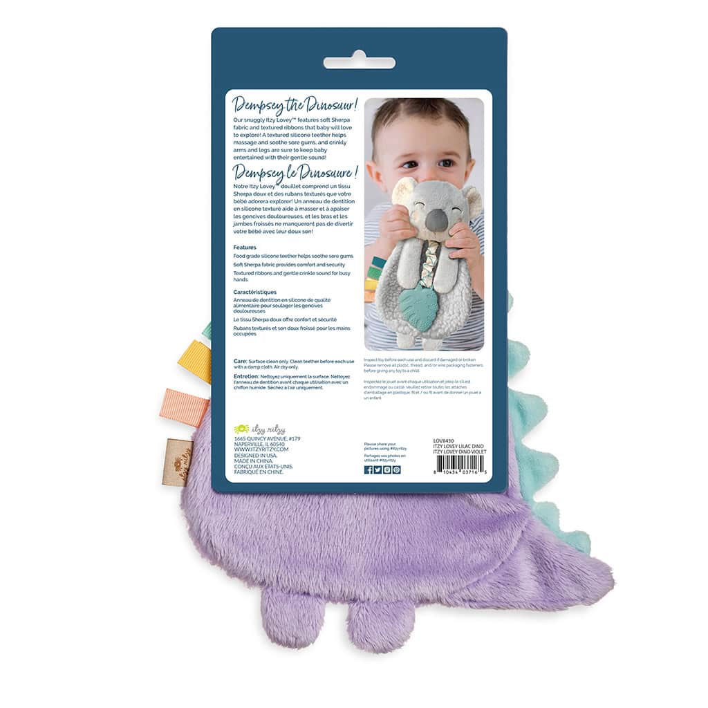 itzy-ritzy-lov8430-itzy-lovey-purple-dino-4 A product package displaying a photograph of a child holding a stuffed dinosaur toy. The package lists features, care instructions, and contact information of the manufacturer.