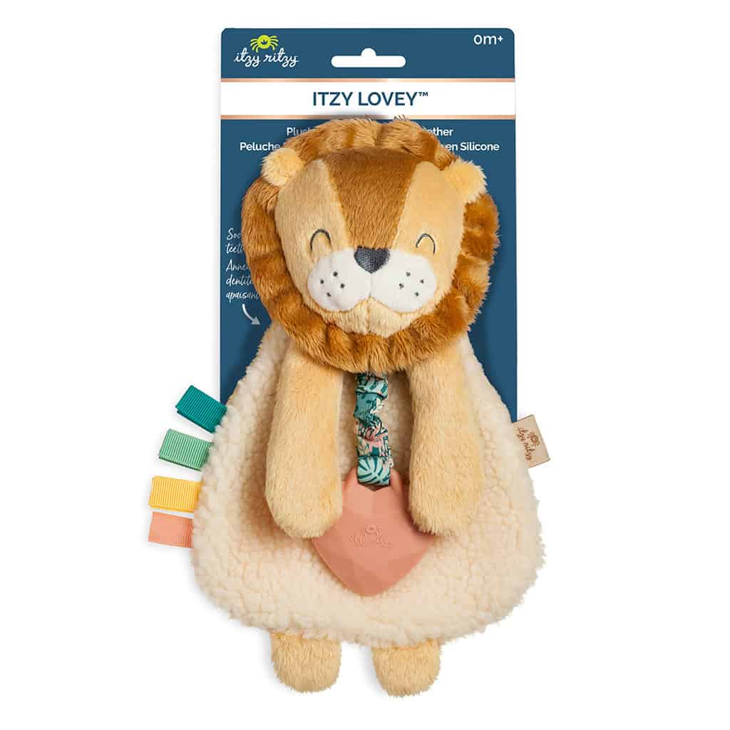 itzy-ritzy-lov8472-itzy-lovey-lion-1 A plush lion toy for infants with a fluffy mane, colorful fabric tags on the side, and a heart-shaped silicone teether attached, packaged on a blue cardboard backer.