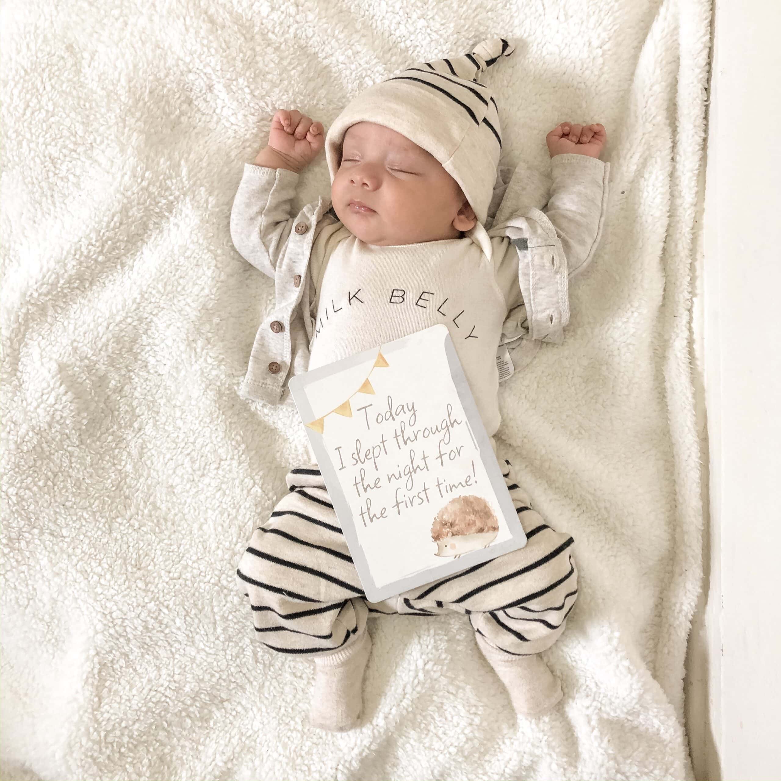 itzy-ritzy-mc8383-itzy-moments-woodland-10 A newborn baby laying on a blanket with a card.
