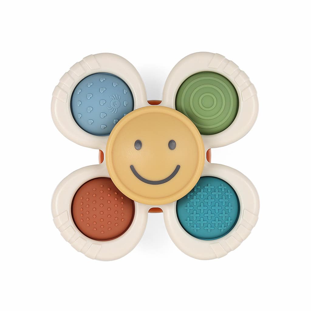 itzy-ritzy-spin8547-itzy-pop-&-whirl-smile-_2 A sensory toy in the shape of a flower with five rounded petals, each featuring different textures and colors. The center is yellow with a smiling face.
