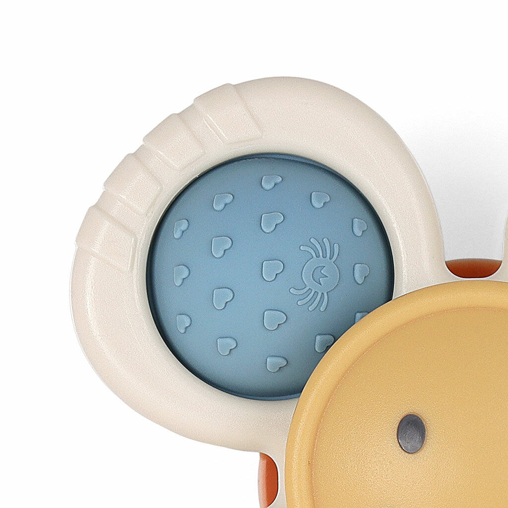 itzy-ritzy-spin8547-itzy-pop-&-whirl-smile-_3 A close-up of a baby teething toy featuring a round, blue textured section with heart patterns and a small spider icon, set against a white and yellow background.