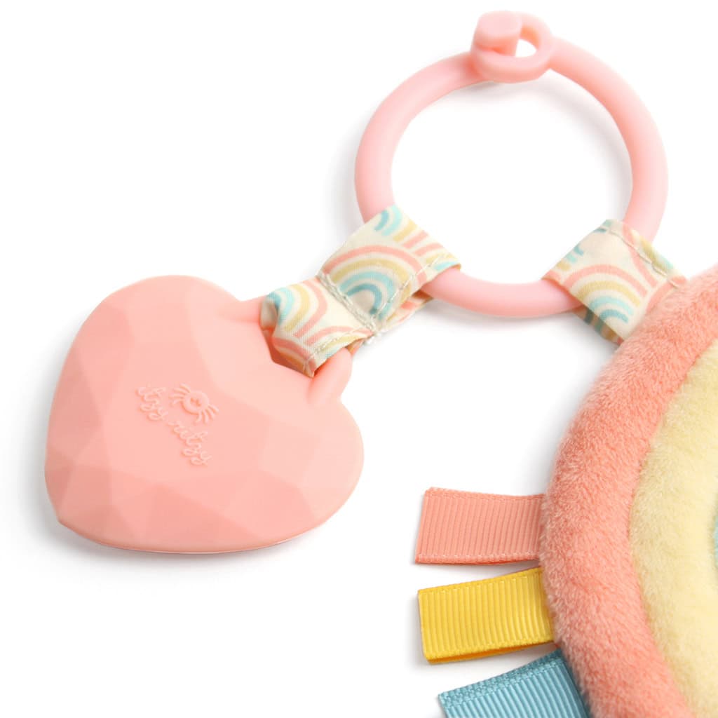 itzy-ritzy-tpl3003-itzy-pal-rainbow-4 Itzy Ritzy - Itzy Pal - Plush Pal Infant Toy with Silicone Teether with pink handle and heart-shaped attachment, accompanied by colorful ribbons and a plush yellow fabric.