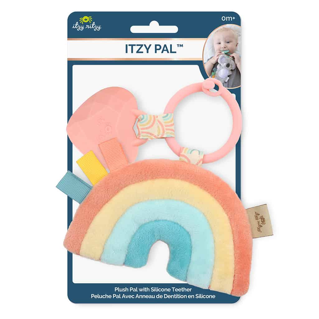 itzy-ritzy-tpl3003-itzy-pal-rainbow Packaged baby teething toy featuring a plush rainbow with a silicone teether and colorful tags, branded as "Itzy Ritzy - Itzy Pal - Plush Pal Infant Toy with Silicone Teether," displayed in a retail hanging card.