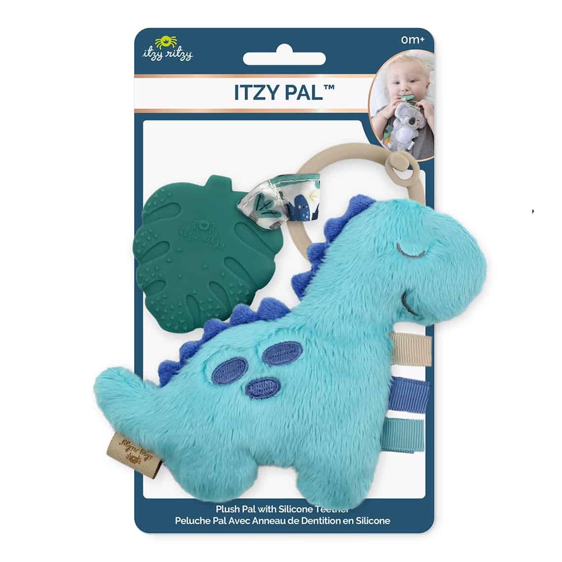 itzy-ritzy-tpl8449-itzy-pal-dino Packaged Itzy Ritzy - Itzy Pal plush blue dinosaur toy with silicone teether and strap, displayed next to an image of a baby using the teether.